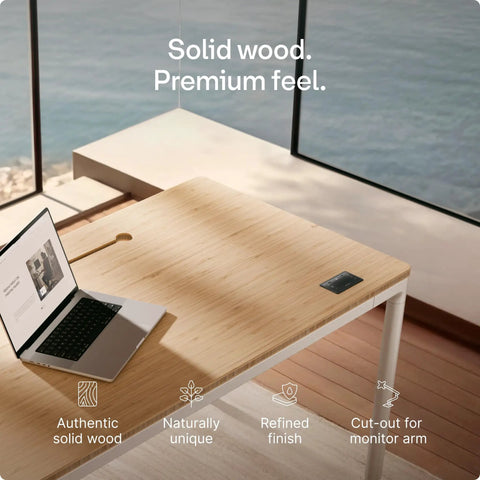 Rock Solid Electric Standing Desk Gliding Smoothly On Ultra Quiet Quad Motors Sixty Three Inch Worktop with solid wood surface.