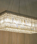 Modern Raindrop K9 Crystal Rectangle Showstopper Chandelier With 11-Light Linear Pendant, chrome finish and adjustable chain.