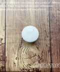 White Ceramic Round Kitchen Cabinet Knobs 10 Pack With Long And Short Screws For Drawers Cabinets Dresser Wardrobe Closet Vintage Style Hardware That Feels Great In The Hand resting on wooden surface