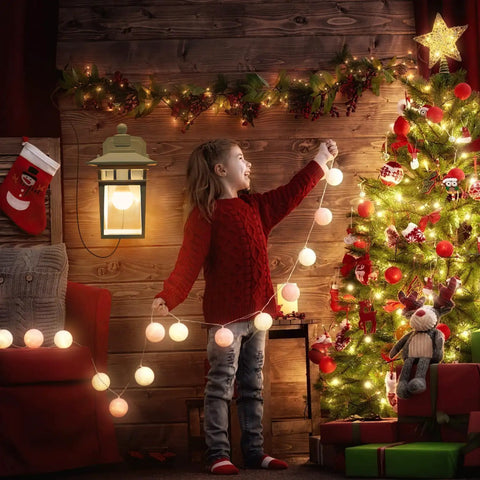 Child decorating a cozy room with a Durable Dusk To Dawn Outdoor Porch Light with GFCI Outlet beside a Christmas tree.