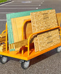 Uyoyous 6-inch heavy-duty caster wheels set of 4 on an orange cart carrying plywood boards; 2 locking, 2 non-locking