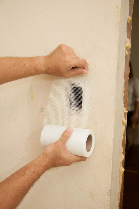 Applying Onetime Fiber Mesh Crack Patch Wall Repair Fabric 6 Inch By 75 Foot Self Adhesive on drywall corner
