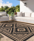 Reversible Waterproof Outdoor Rug 5x8 Ft For Patio Deck Porch RV Beach And Backyard With Black And Brown Geometric Pattern laid on patio