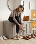 Waterproof UV Resistant Shoe Cabinet Storage Bench Indoor Outdoor With Adjustable Shelves Double Door Grey For Entryway Bedroom Hallway And Living Room Durable Space Saving Organizer That Holds Up To Eight Pairs, with a woman seated on it, shoes visible.