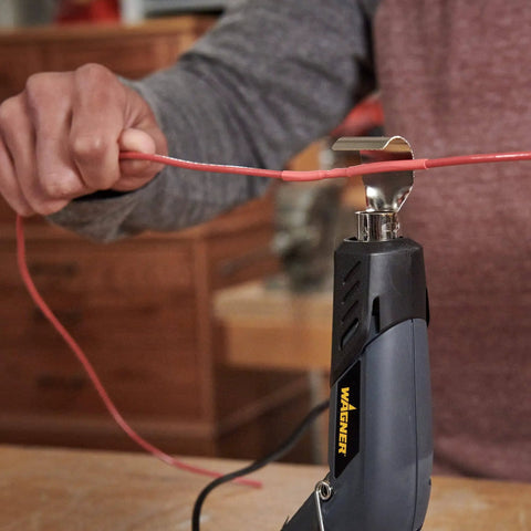 Person using All In One Dual Temperature Electric Heat Gun Kit HT400 680F And 450F for wire repair with shrink tubing