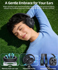 Woman relaxing on grass wearing Hybrid Active Noise Canceling Wireless Headphones With 120-Hour Battery Life Bluetooth 6.0 Over-Ear Headphones, ENC HD Mic For Crystal Clear Calls, Hi-Res 360 Spatial Audio, Built For Travel And Gym, Black with visuals of ear cushions and adjustable frame.