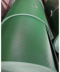 Green roll of light duty conveyor belt showing textured surface.