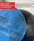 Close-up of 1000 Grit Bowling Ball Sanding Disc Kit for Resurfacing Machines Ball Spinner and Hand Cleaning Pro Grade Pad in use.