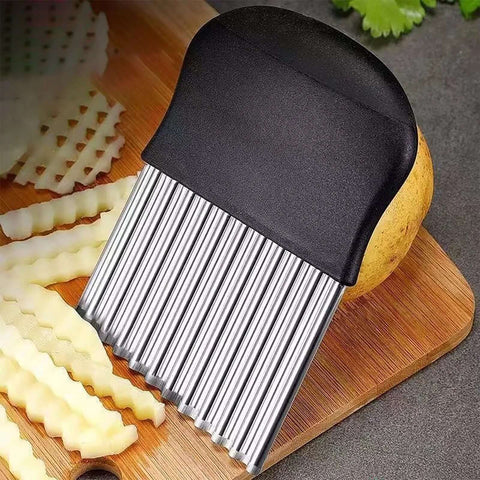 Crinkle cutter and 2-in-1 vegetable peeler with black handle and ribbed stainless blades on a wooden cutting board