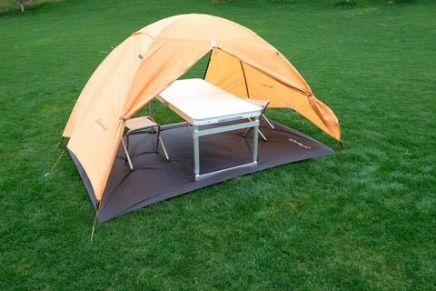 Tent Footprint Ground Cloth Waterproof Tarp Heavy Duty Tent Floor Saver under orange tent with table and chairs on grass