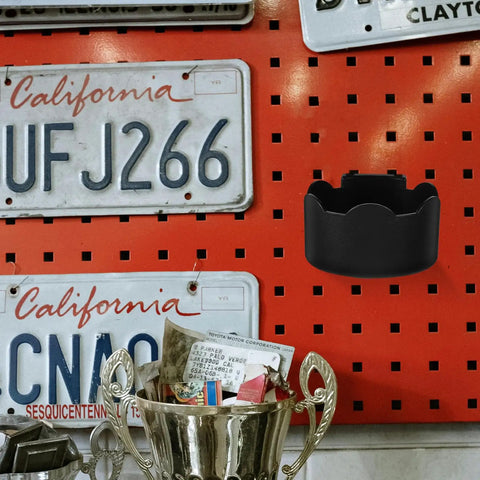 Black Plastic Aerosol Can Holder Wall Mount Organizer on red pegboard with license plates