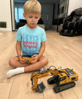 Child playing with 11 Channel RC Excavator Toy For Kids 3-12, Metal Construction Truck in living room