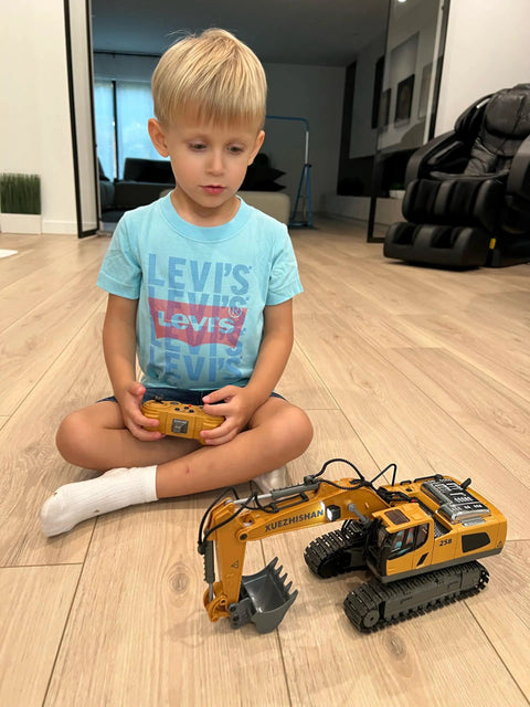 Child playing with 11 Channel RC Excavator Toy For Kids 3-12, Metal Construction Truck in living room