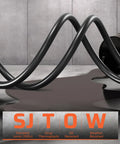 Heavy Duty 50 Ft Retractable Extension Cord Reel With 3 Grounded Outlets Lit Triple Tap 13 Amp Circuit Breaker 14AWG SJTOW Cord UL Listed Oil And Water Resistant Power Station For Indoor Outdoor Work shown coiled on floor, highlighting SJTOW oil resistance properties.