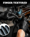 Close-up of black nitrile gloves on a mechanic repairing a bicycle frame.