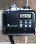 Outdoor Timer With 7 Day Programming And Astronomic Self Adjust With No Fuss For Sunrise Sunset on brick wall with snow.