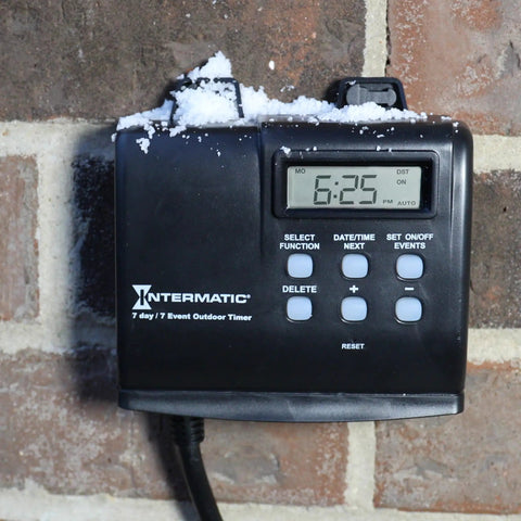 Outdoor Timer With 7 Day Programming And Astronomic Self Adjust With No Fuss For Sunrise Sunset on brick wall with snow.