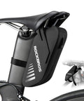 Waterproof 0.6L bike saddle bag and frame bag in grey black, mounted under a bicycle seat with rainproof zippers and durable construction.