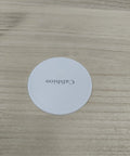 Heavy Duty Furniture Moving Sliders And Round Glide Pads For Carpet Hardwood Floors, round white pad on wooden surface.