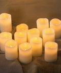 12 Pack Flameless Candles With Real Wax Battery Operated LED Pillar Candles Unscented Ivory Color Including Remote Control And 24 Hour Timer Diameter 3 Inches Height 4 Inches Perfect For Cozy Home Vibes Parties Weddings And Events arranged in a group