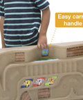 Child holding On The Go Kid Friendly Race Track Table With 2-Sided Play Surface For Cars And Trains, easy carry handle shown