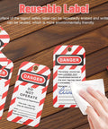 Heavy Duty Lockout Tagout Tags Reusable Do Not Operate Labels For Industrial Jobsite Maintenance Featuring Tough Metal And Pvc Build that shows a hand wiping a safety label.