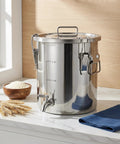 Straight Up Heavy Duty 304 Stainless Steel Beverage Dispenser With Easy Flow Spigot on countertop with rice bowl.