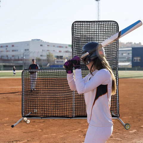 L Screen Baseball Pitching Net With Wheels, 7x7 Ft Heavy Duty Portable Steel Frame used during batting practice on a field