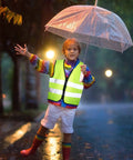 Child wearing Kids Reflective Safety Vest 20 Pack High Visibility Neon Vests With Zipper For Ages 3 To 10 Cycling Running Green in rain.
