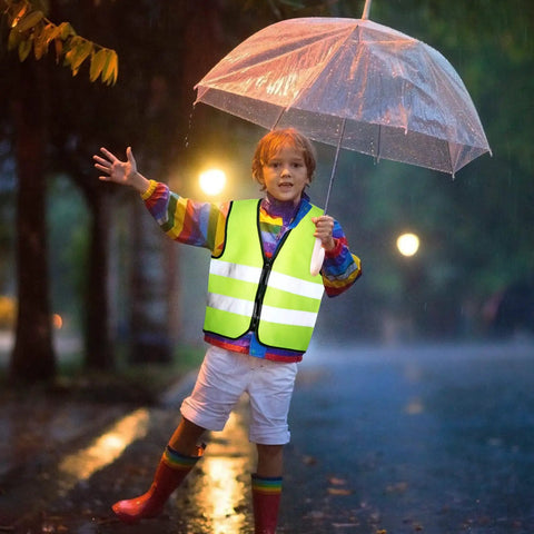 Child wearing Kids Reflective Safety Vest 20 Pack High Visibility Neon Vests With Zipper For Ages 3 To 10 Cycling Running Green in rain.