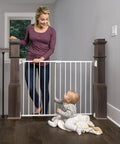 Woman and baby by Ultra Wide Baby Gate For Stairs And Hallways Expands From 24 To 40.5 Inches With A Walk Through Door Hardware Mounted 2 In 1 Gate For Babies Toddlers And Pets Kid And Pet Friendly White.