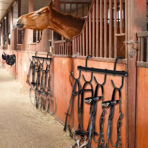Two Pack Black Tack Rack With 360 Degree Swivel Hooks For Horse Bridle Hangers Portable Stall Barn Fence Trailer Organizer Six Hook Horse Gear Storage mounted in a stable with horse gear.