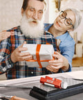 Elderly couple with gift box next to Pro Grade All In One Woodworking Honing Guide For Chisels And Planes With Adjustable Angles