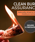 Hand holding a lit natural fire starter from Oak Kiln Dried Five To Six Inch Mini Pizza Oven Logs Bundle 12 To 14 Lbs With Ten Natural Fire Starters