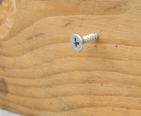 Hella Tough Phillips Flat Head Wood Screws Assortment Kit With Driver Bit, Heavy Duty Self Tapping Fasteners embedded in wood.
