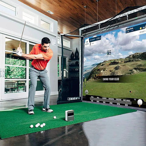 Indoor Golf Simulator Setup For Home And Commercial Use, Four Size Options, Includes HD Impact Screen, Compatible With All Golf Launch Monitors For Realistic Practice And Training showing a man golfing with realistic scenery.