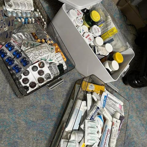 White 4-tier medicine storage organizer with handle; set of three shown with pills, bottles and tubes in removable trays