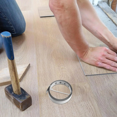 No Fuss Self Adhesive One Meter Steel Metric Track Ruler Tape used for flooring installation with hammer and flooring planks.