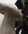 Close-up of mushroom sculpture being refined with No Nonsense Heavy Hitter 8 Amp Mini Wood Carving Router for detailed work.
