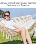 Handwoven Tassel Hammock With Stand For Outdoor Use Oversized Double Hammock Holds Up To 450 Lbs Super Comfy Pillow And Storage Bag Included Easy Setup Portable Stand Beige with person relaxing on it outdoors
