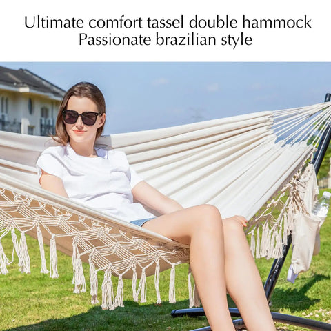 Handwoven Tassel Hammock With Stand For Outdoor Use Oversized Double Hammock Holds Up To 450 Lbs Super Comfy Pillow And Storage Bag Included Easy Setup Portable Stand Beige with person relaxing on it outdoors