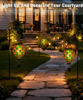 Mosaic Glass Hot Air Balloon Solar Lanterns With Flickering Flame Effect illuminating garden path at night