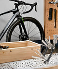 All In One Carbon Steel Bike Multi Tool with 12 Precision Tools near mountain bike and tool rack
