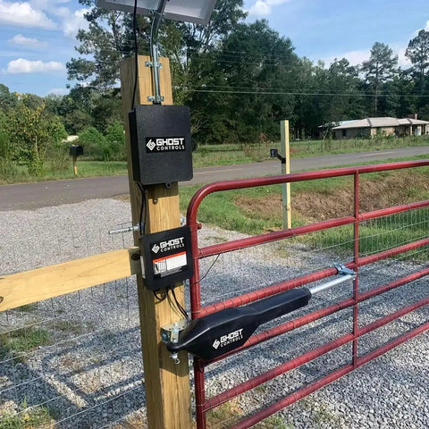 Lockable Weatherproof Battery Box Kit With Two 12V 7.0Ah Batteries, Harness, And Post Mount installed on a gate post.