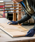 Person cleaning wood surface with cloth for Raw Wood Cleaner For Prep And Finish Electrostatic Dust Removal After Sanding And Vacuuming.