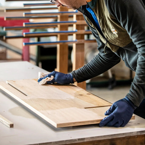 Person cleaning wood surface with cloth for Raw Wood Cleaner For Prep And Finish Electrostatic Dust Removal After Sanding And Vacuuming.