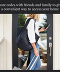 Woman using phone to unlock door with Worlds Smallest Smart Lock With Built In Matter And Bluetooth Hiding Tech Inside Your Door