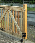 Heavy Duty Spring Loaded Gate Caster Wheel With 360 Degree Swivel And Universal Mount Plate Leveling Bracket attached to wooden gate