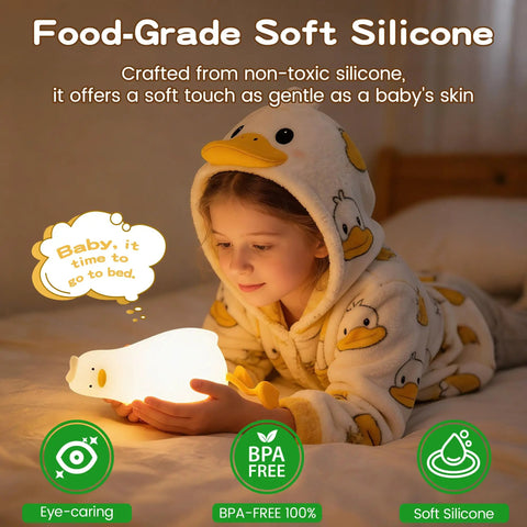 Child holding a Squishy Silicone Rubber Duck Night Light For Nursery Baby And Kids Dimmable Rechargeable Touch Led Lamp BPA Free Non Toxic Bedside Light For Breastfeeding and Shatterproof Safe Cozy Glow, wearing duck-pattern pajamas in a dimly lit room.