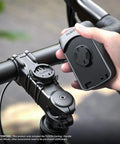 Hand holding GPS unit near Two Pack Stem Mount For Wahoo ELEMNT Bike Computers Fits ROAM BOLT MINI And More on bike handlebar